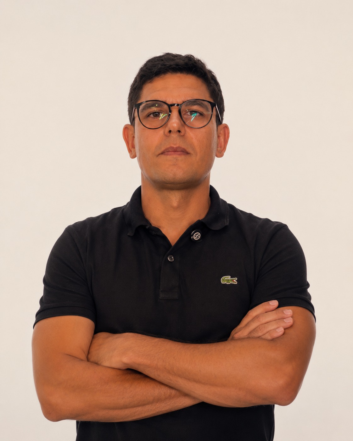 Erinaldo Rolemberg, de braços cruzados, óculos e camisa polo preta
